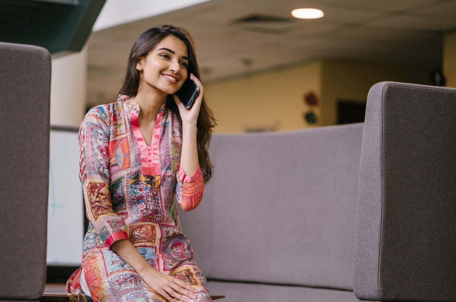 photo-of-smiling-woman-in-floral-salwar-kameez-talking-on-2559055
